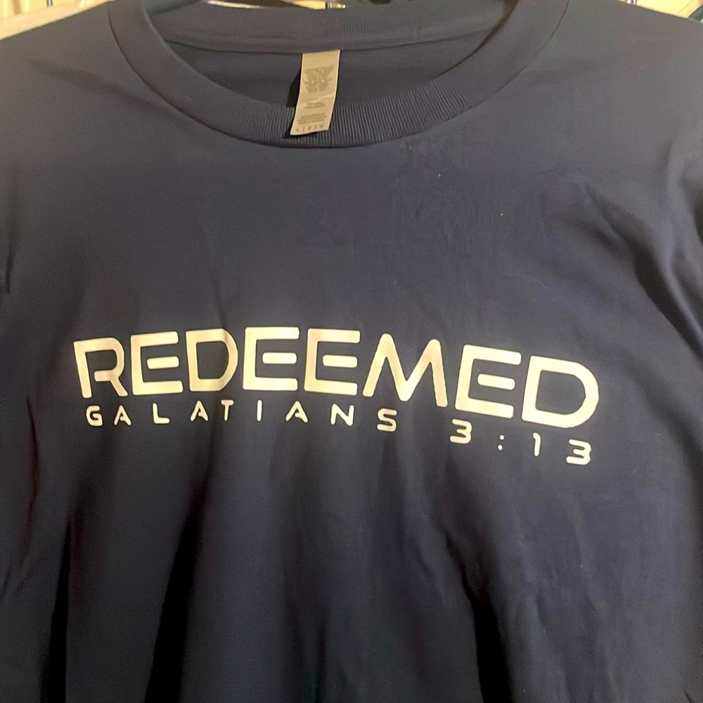 A large, man, dark blue “Redeemed” Christian t-shirt.